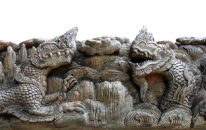 "King Of Nagas & Kylin Carving On Teak" by kornnphoto